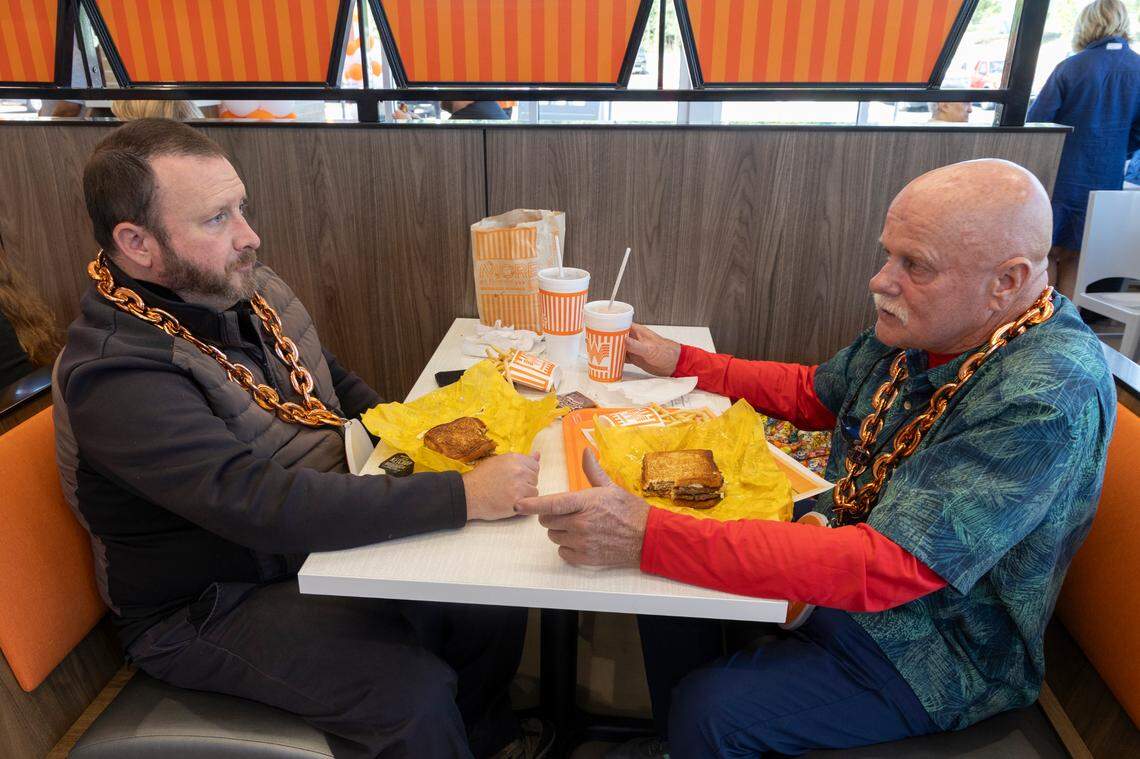 Connor Smoak, left, and Phil Foust dine during the grand opening of the Whataburger in Irmo on Monday, Sept. 9, 2024. The two became friends while waiting overnight to be the first people in line when the restaurant opened.