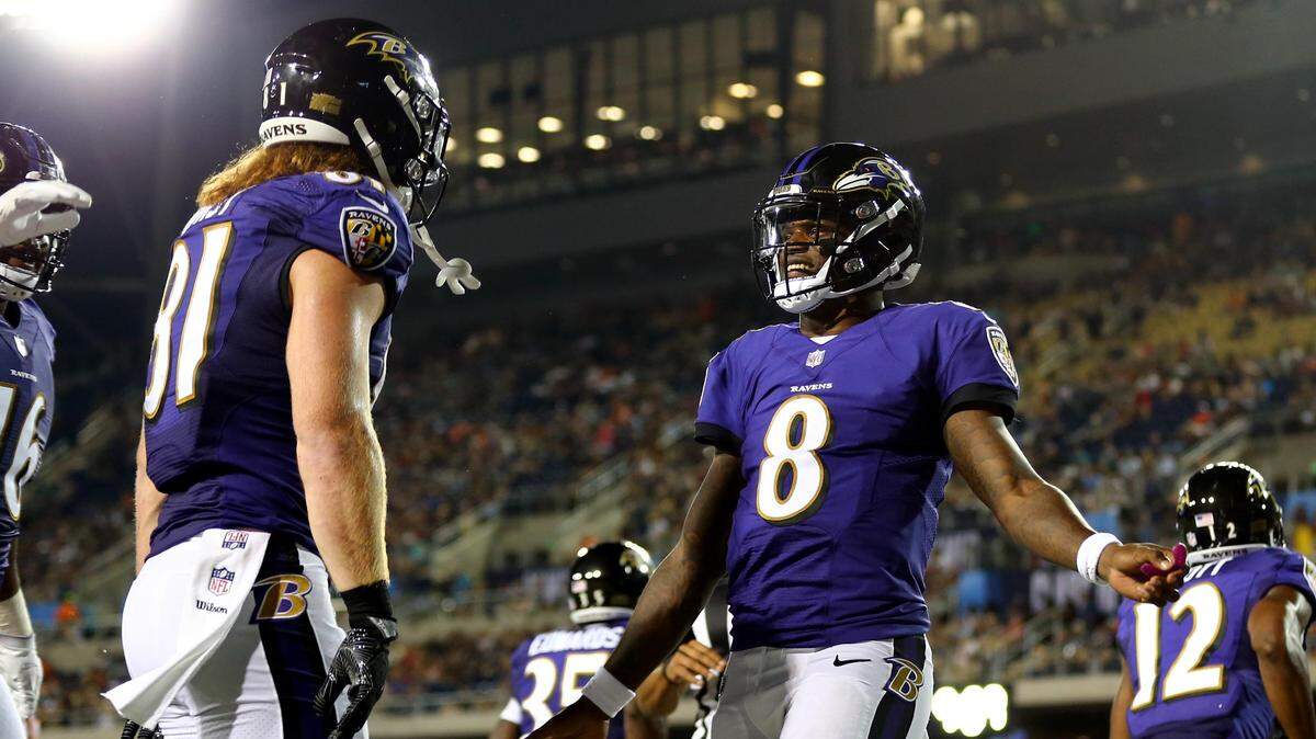 Aug 2, 2018; Canton, OH, USA; Baltimore Ravens tight end Hayden Hurst (left) celebrates scoring a touchdown with quarterback Lamar Jackson (8) against the Chicago Bears in the second half at Tom Benson Hall of Fame Stadium.