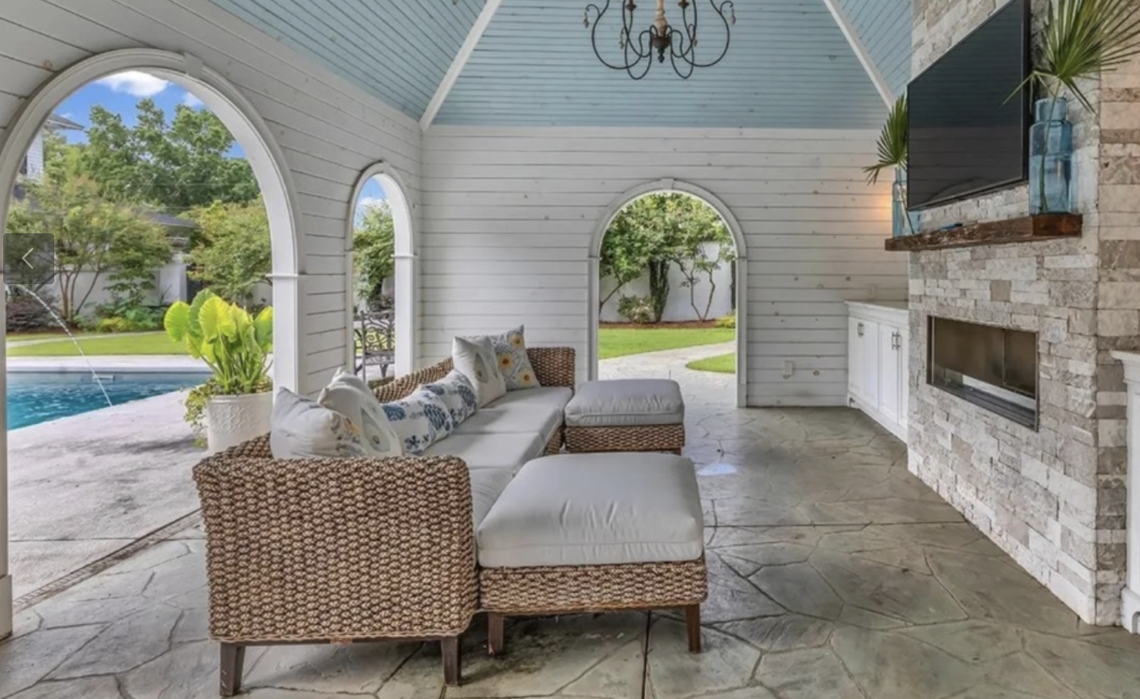 The garden in the rear leads to a saltwater pool and cabana with a gas fireplace, mini fridge, and microwave.