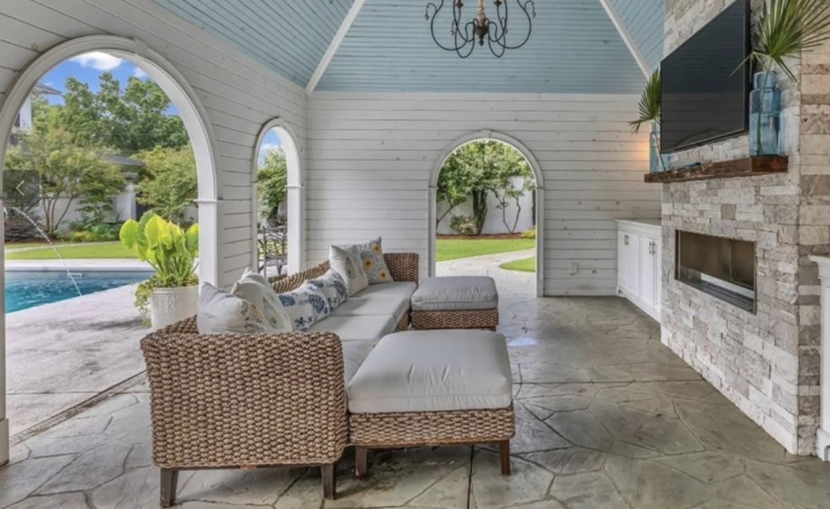 The garden in the rear leads to a saltwater pool and cabana with a gas fireplace, mini fridge, and microwave.
