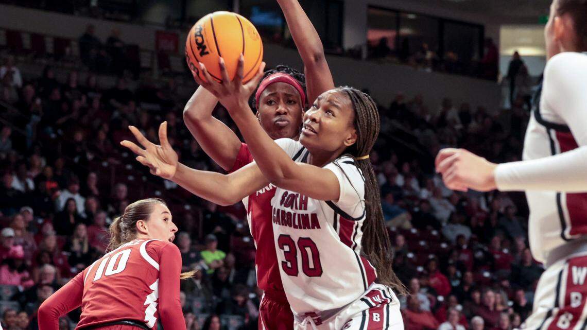 University of South Carolina’s Maryam Dauda (30) shoots as Arkansas’ Kiki Smith (2)2 defends during the second half of action in the Colonial Life Arena on Thursday, Feb. 20, 2025.