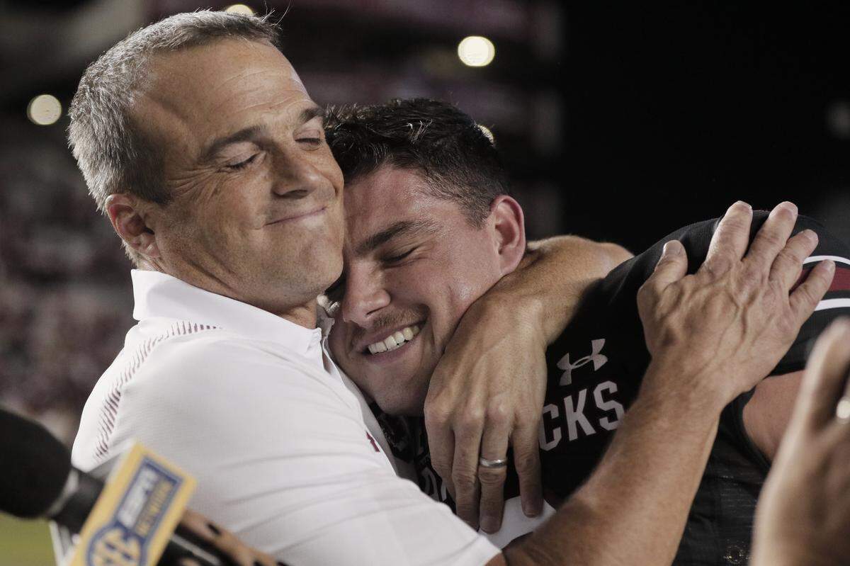 South Carolina head coach Shane Beamer embraces Gamecocks quarterback Zeb Noland after the win over Vanderbilt at Williams-Brice Stadium on Oct. 16, 2021. 