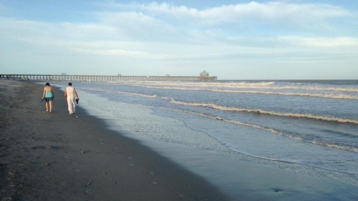 
Two beachcombers stroll along the shore Wednesday morning at Myrtle Beach.
