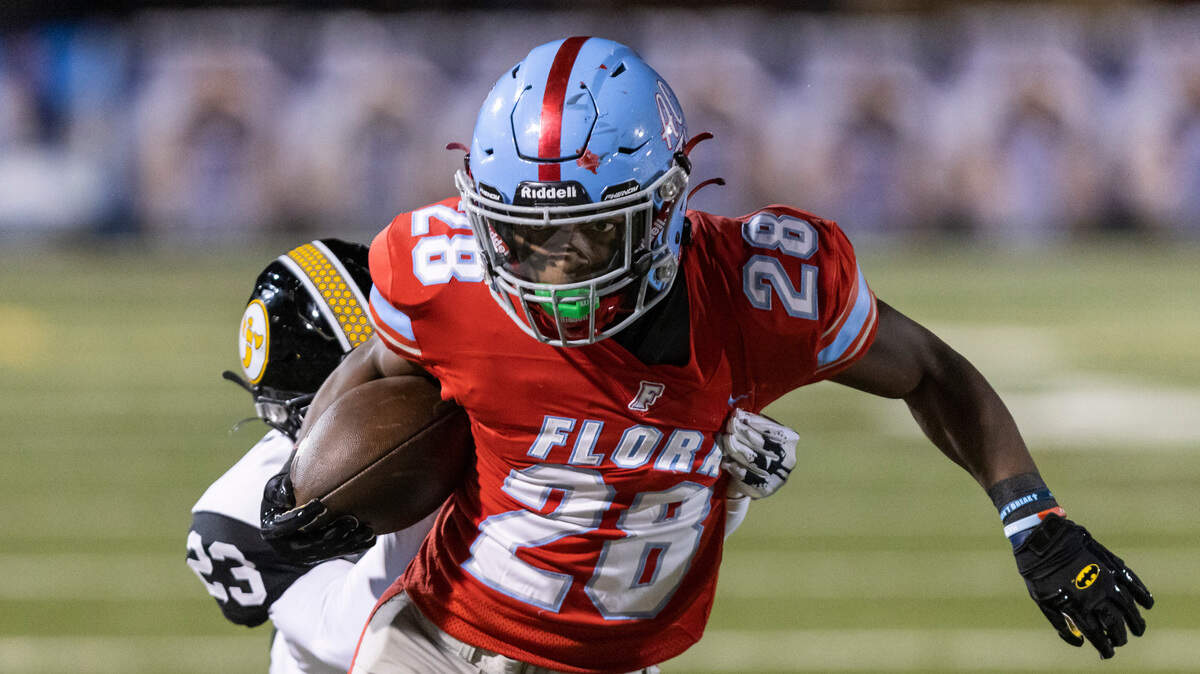 Markel Townsend (28) of AC Flora fends off the tackle of Matthew Blocker (23) of Irmo at Memorial Stadium on Oct. 14, 2022.