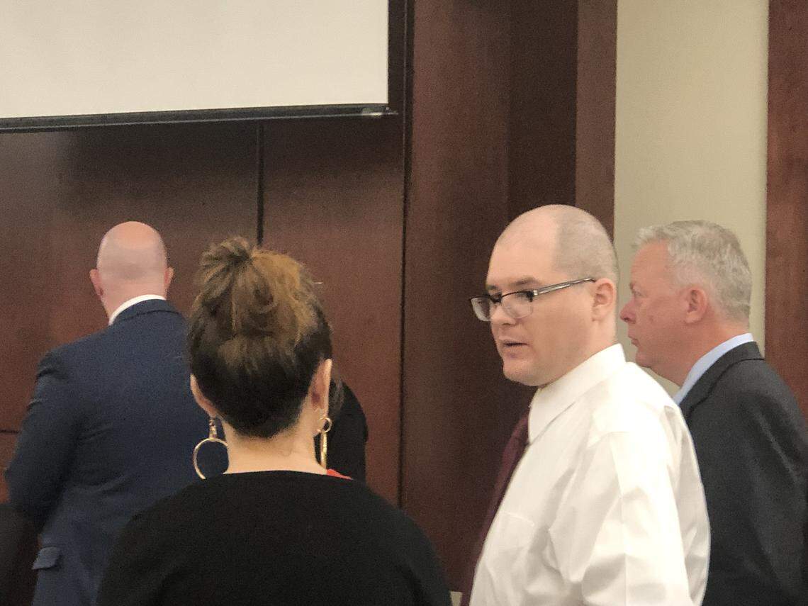 Tim Jones, accused of killing his five children, talks with his legal team during a court break Wednesday.