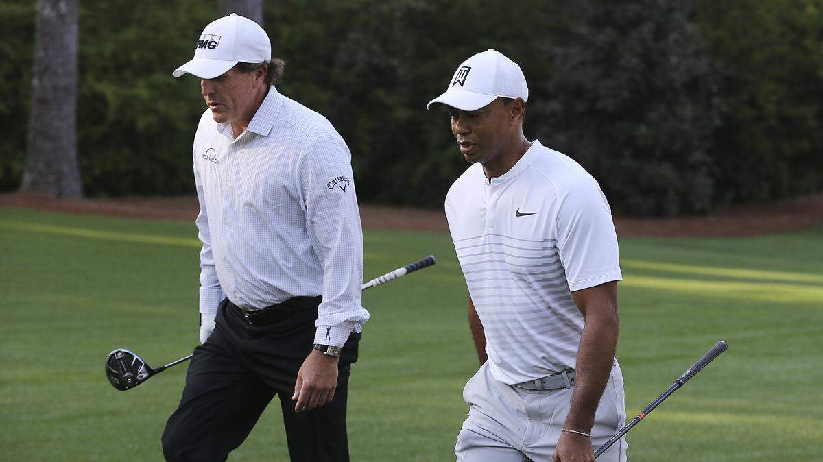Tiger Woods and Phil Mickelson walk Augusta National Golf Club during a practice round for the 2018 Masters. While Mickelson has played the Wells Fargo Championship in Charlotte nearly every year, Woods has not played the tournament since 2012 but stands a good chance of doing so this year.