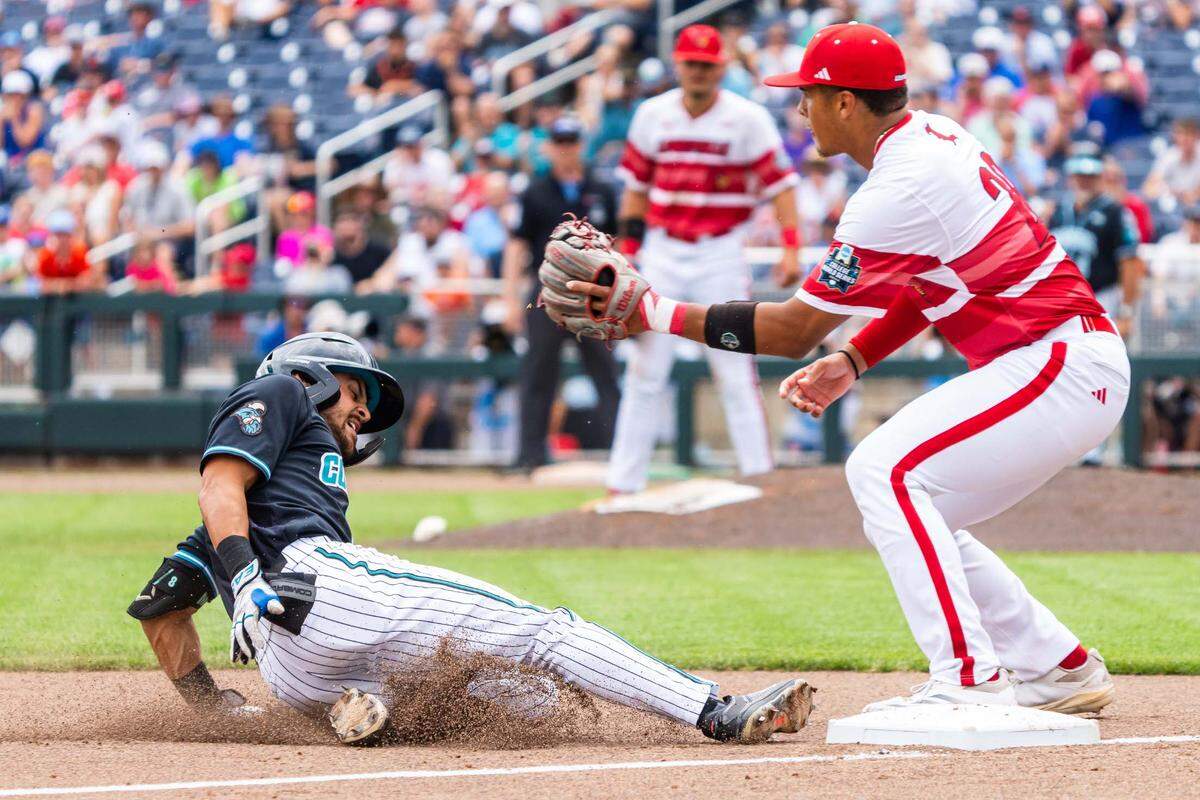 Coastal Carolina Chanticleers designated hitter Dean Mihos (8) slides to third after hitting a two RBI triple against the Louisville Cardinals during the fifth inning at Charles Schwab Field.