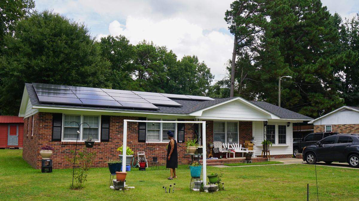 Carnell Conyers, 68, stands in her front yard in Manning, South Carolina on July 26, 2024 and worries that a lien will be placed on her home due to a loan she says she never took out for 17 solar panels.