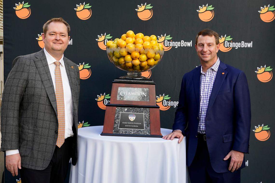 Tennessee head coach Josh Heupel, left, and Clemson head coach Dabo Swinney, right, pose for a photograph during a news conference for the Orange Bowl NCAA college football game, Wednesday, Dec. 7, 2022, in Hollywood, Fla. The two teams will play in the Orange Bowl on Dec. 30. (AP Photo/Lynne Sladky)