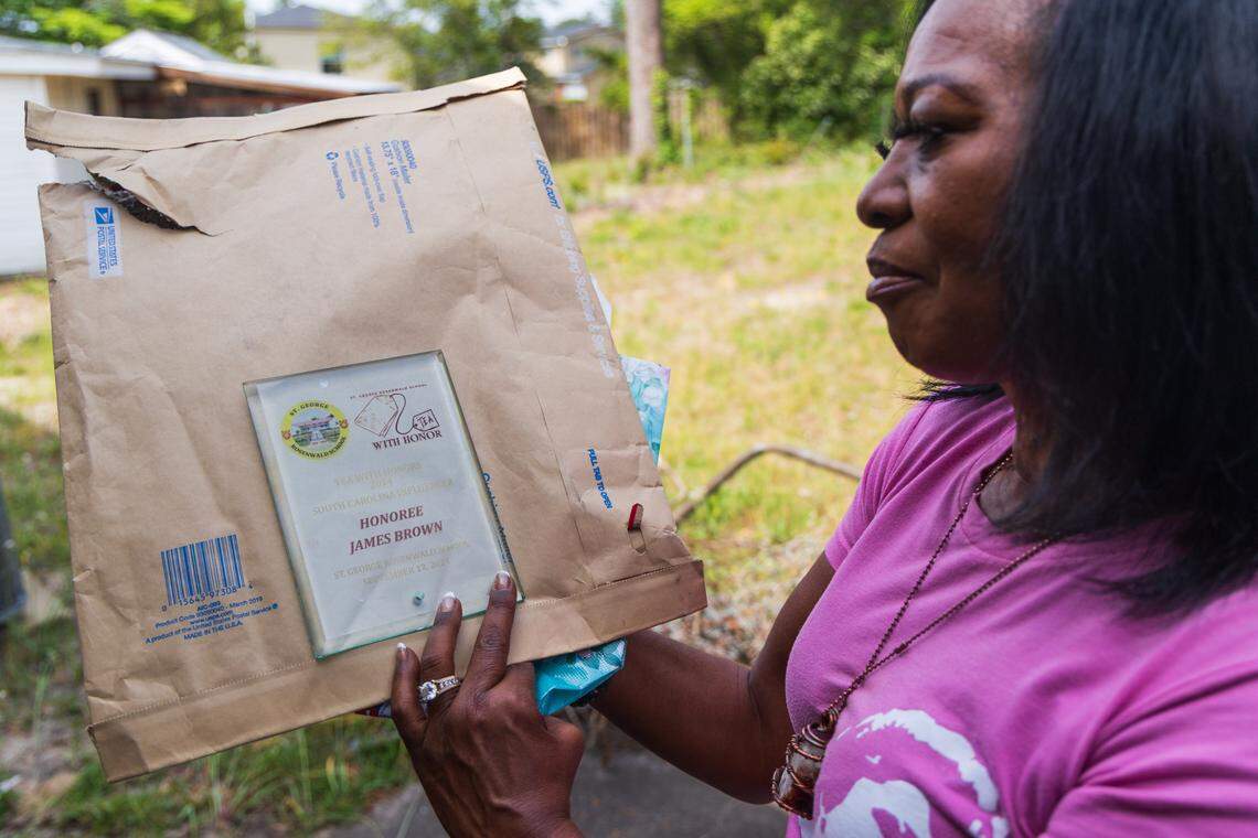 Dr. Deanna Brown Thomas shows an award given to her late father, James Brown, by the St. George Rosenwald School on Tuesday, April 22, 2025. She says her father continues to receive awards, and they are often sent to her. 