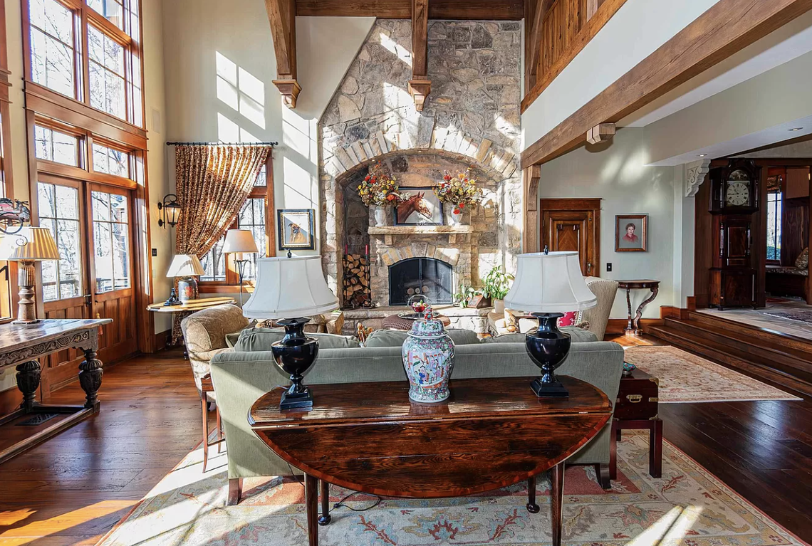 Soaring windows and fireplace are standouts in the living room.