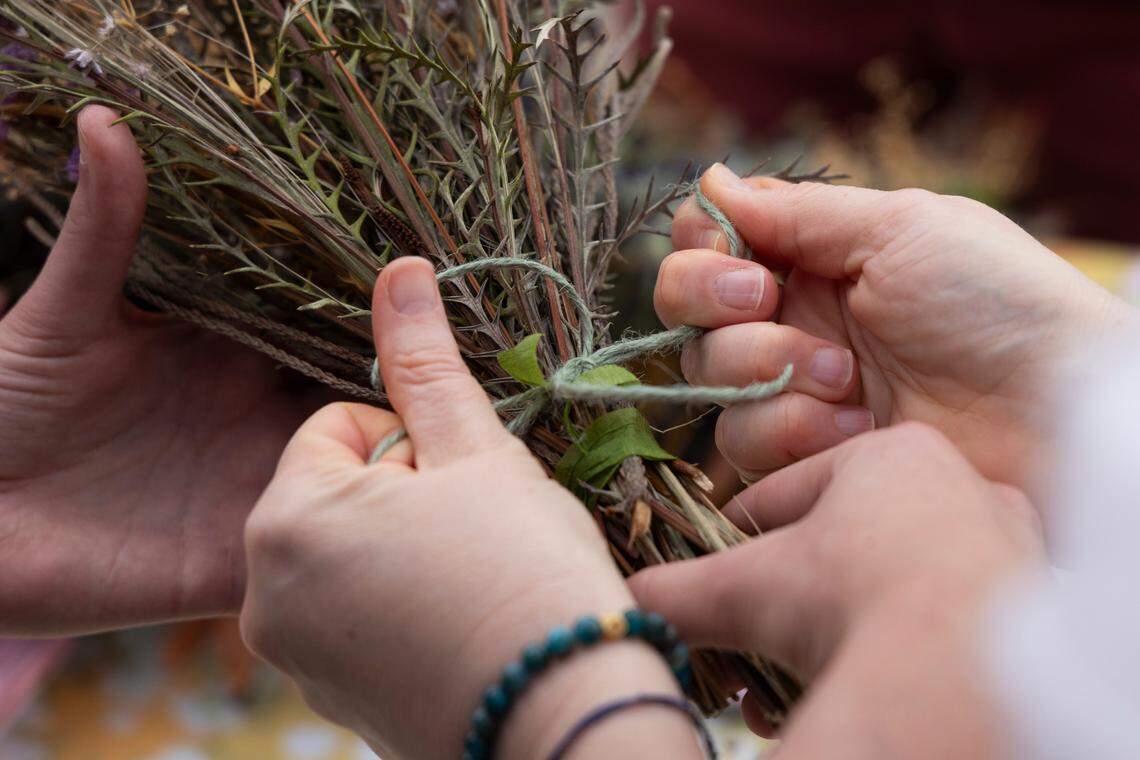 Volunteers make flower arrangements for a mass wedding at Y’all-Mart, a quarterly art fair series, at Art Bar in Columbia, South Carolina on Sunday, February 9, 2025. Eight LGBT couples married during the four hours of the art fair.