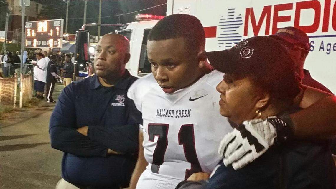 Eric Douglas hugs his mother, Charlene, the night Eric Sr. suffered a stroke at a Mallard Creek High School football game on Sept. 26, 2014.