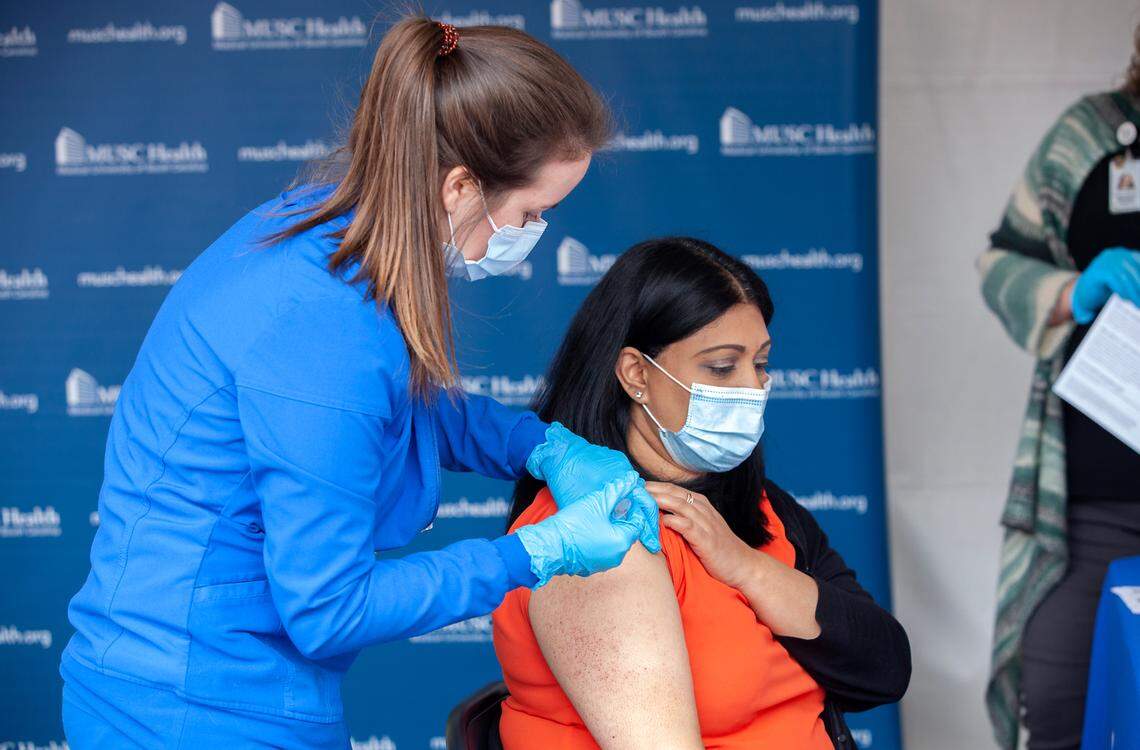 Registered nurse Erika Hutzler, left, administers the Pfizer/BioNTech COVID-19 vaccine at MUSC to Dr. Krutika Kuppalli on December 15, 2020. Kuppalli was among the first in Charleston to get the vaccine.