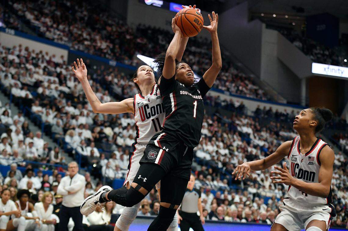 UConn’s Lou Lopez-Senechal (11) blocks a shot by South Carolina’s Zia Cooke (1) in the first half of an NCAA college basketball game, Sunday, Feb. 5, 2023, in Hartford, Conn. (AP Photo/Jessica Hill)