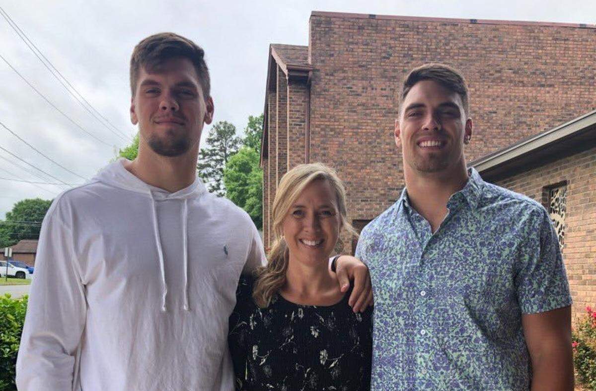 Nick Muse (left) of South Carolina and Tanner Muse (right) of Clemson pose with their mom Shannon Muse.