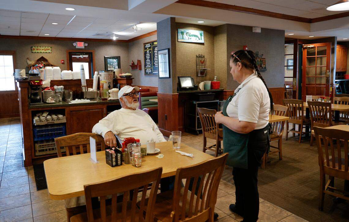 Carolyn Dowdy, who has worked at Lizard’s Thicket for 18 years, visits with H.V. Pruitt. Pruitt dines at Lizard’s Thicket daily.