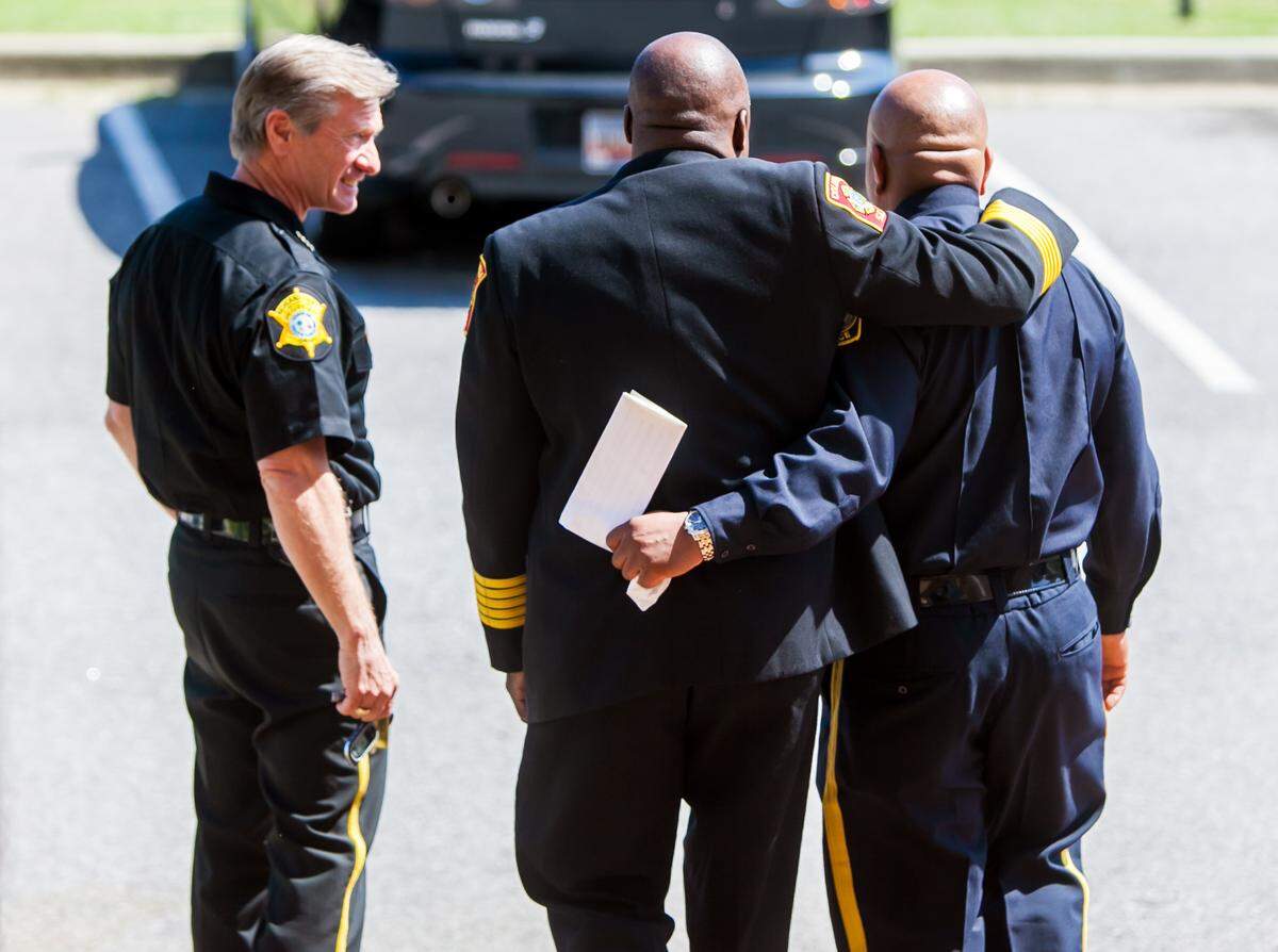 Richland County Sheriff Leon Lott, left, and Columbia-Richland Fire Chief Aubrey Jenkins, middle, escort out Columbia Police Chief Randy Scott after Scott announced his resignation Monday. Scott suffered from PTSD after a deputy he hired while he worked at the Richland County Sheriff’s Department was killed in 2005.