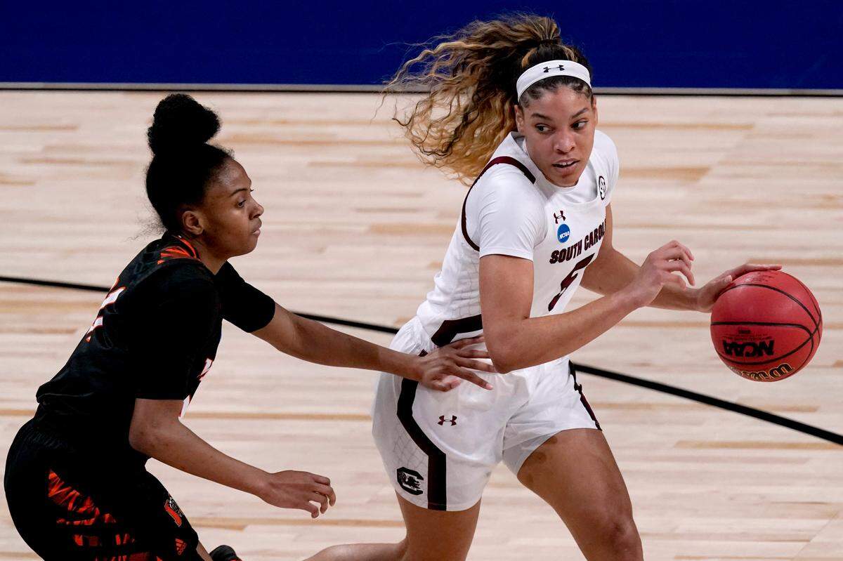 South Carolina forward Victaria Saxton, right, is pressured by Mercer guard Shannon Titus, left, during the first half of a college basketball game in the first round of the women’s NCAA tournament at the Alamodome in San Antonio, Sunday, March 21, 2021.