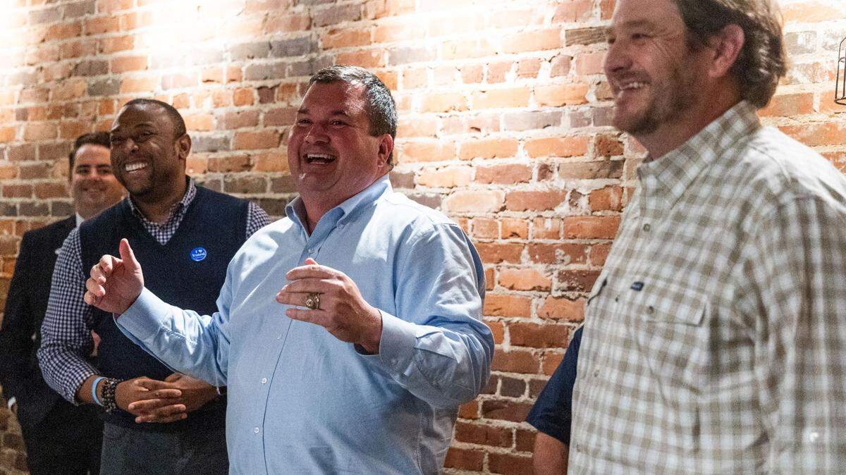 West Columbia Mayor Tem Miles, center, celebrates his reelection at a victory party at Savage Craft, Nov. 7, 2023.