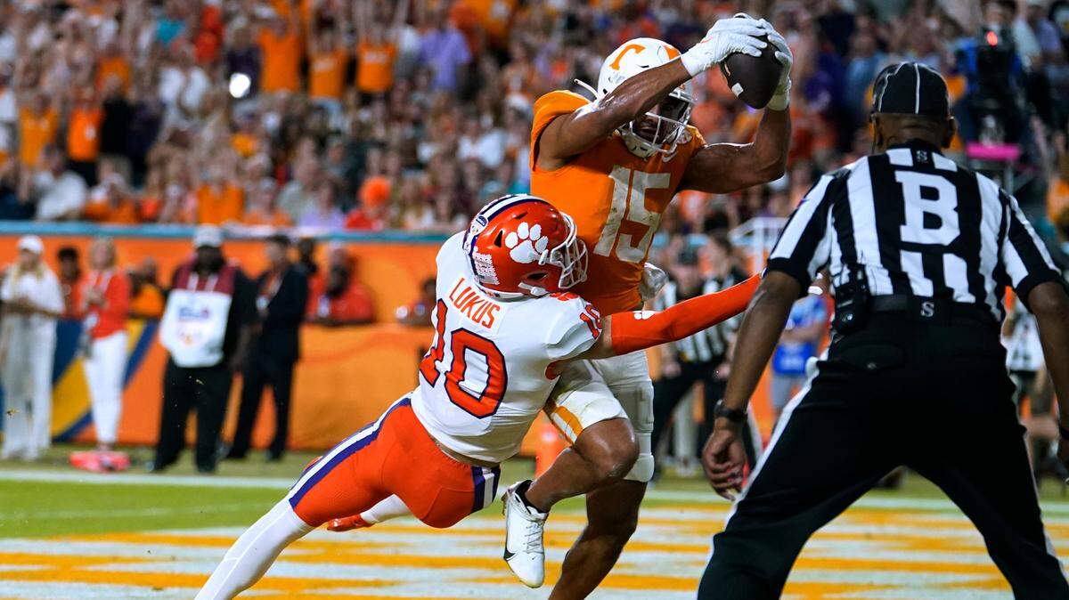 Tennessee wide receiver Bru McCoy (15) scores a touchdown as Clemson cornerback Jeadyn Lukus (10) defends during the first half of the Orange Bowl NCAA college football game Friday, Dec. 30, 2022, in Miami Gardens, Fla. (AP Photo/Lynne Sladky)