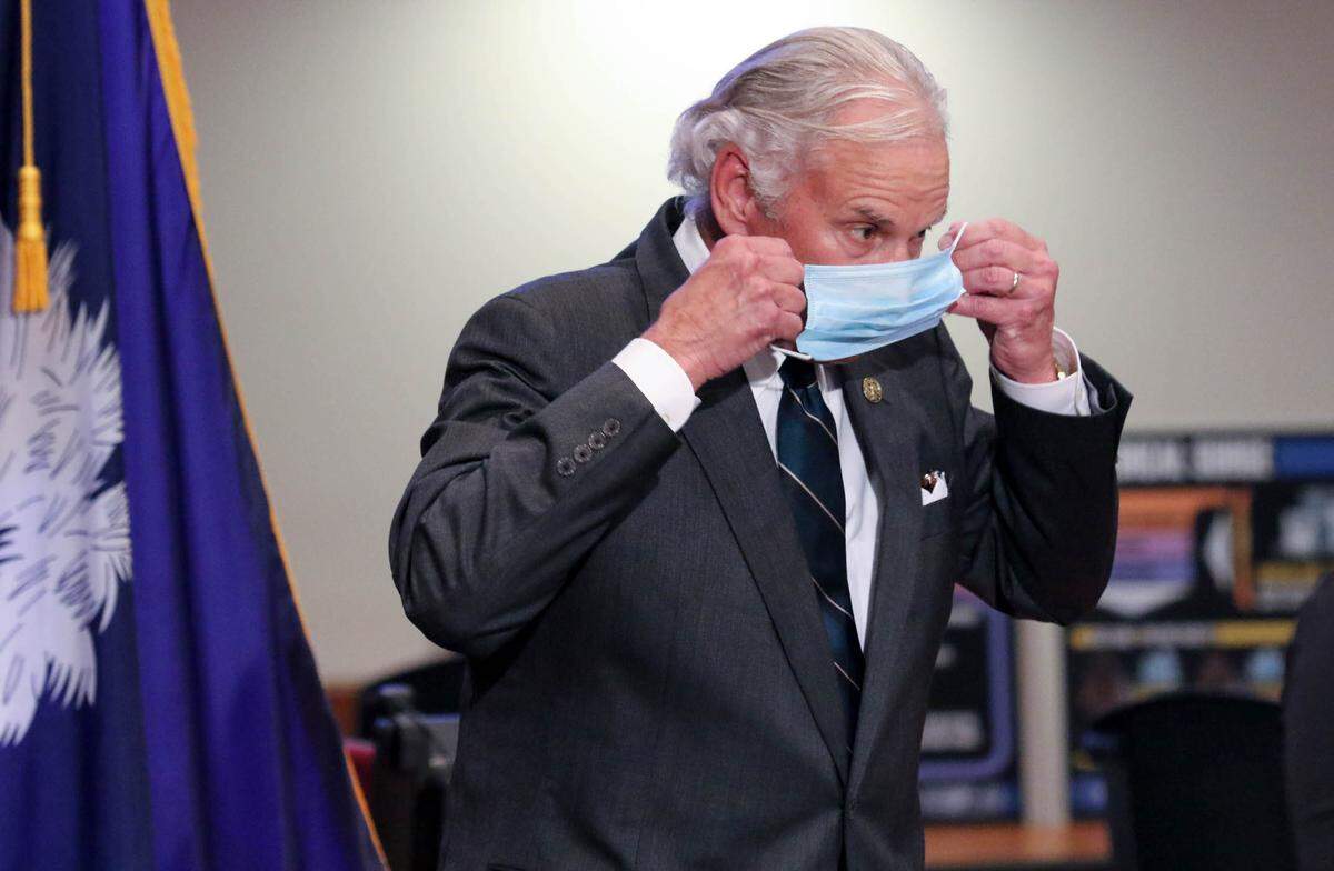 SC Governor Henry McMaster puts on a mask after speaking during a press conference at the South Carolina Emergency Management Division. 7/29/20