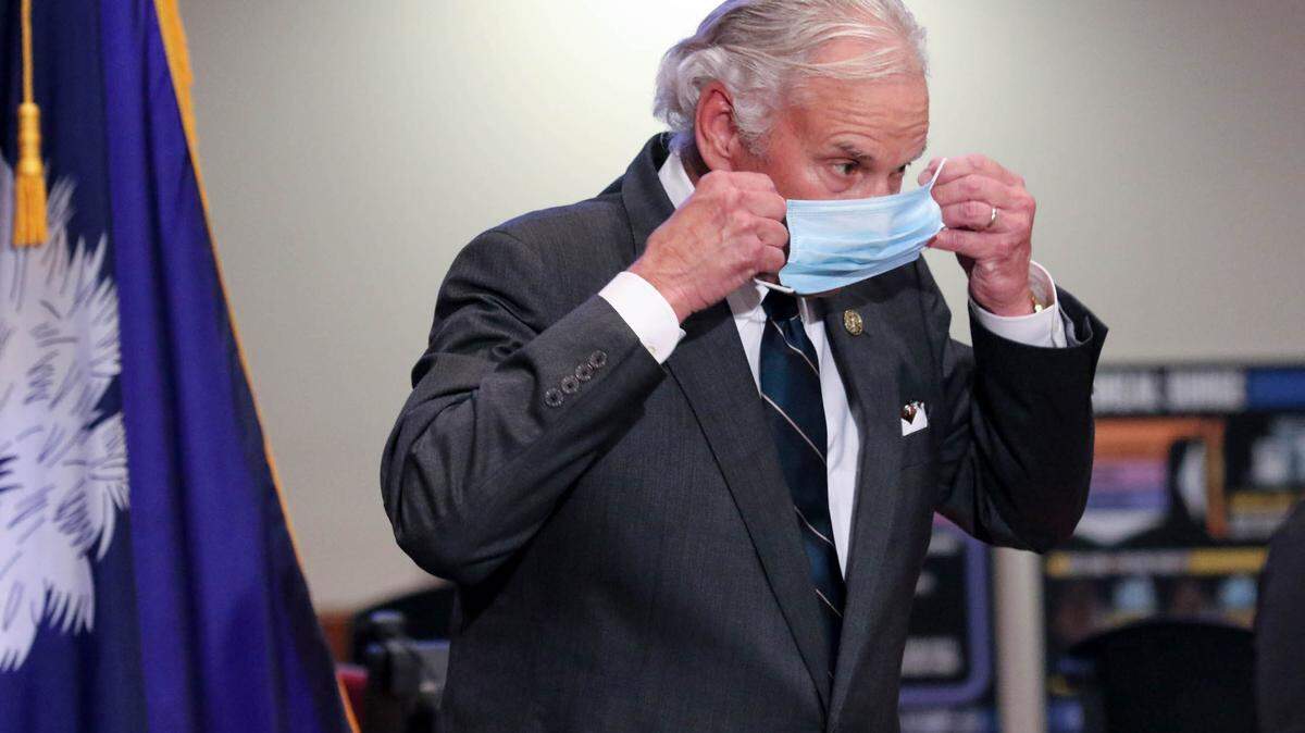 SC Governor Henry McMaster puts on a mask after speaking during a COVID-19 press conference last year. Last month, McMaster tested positive for coronavirus and has been in quarantine.