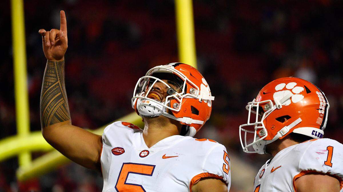 Clemson quarterback D.J. Uiagalelei (5) gestures to the crowd after scoring a touchdown during the second half of an NCAA college football game in Louisville, Ky., Saturday, Nov. 6, 2021. Clemson running back Will Shipley (1) looks on. (AP Photo/Timothy D. Easley)