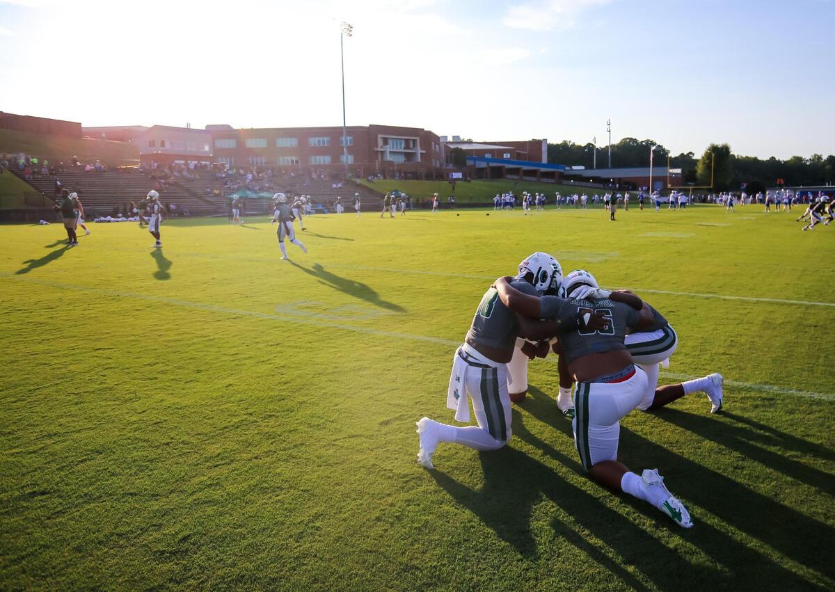 Dutch Fork Silver Foxes players pray before the game against the Byrnes Rebels.