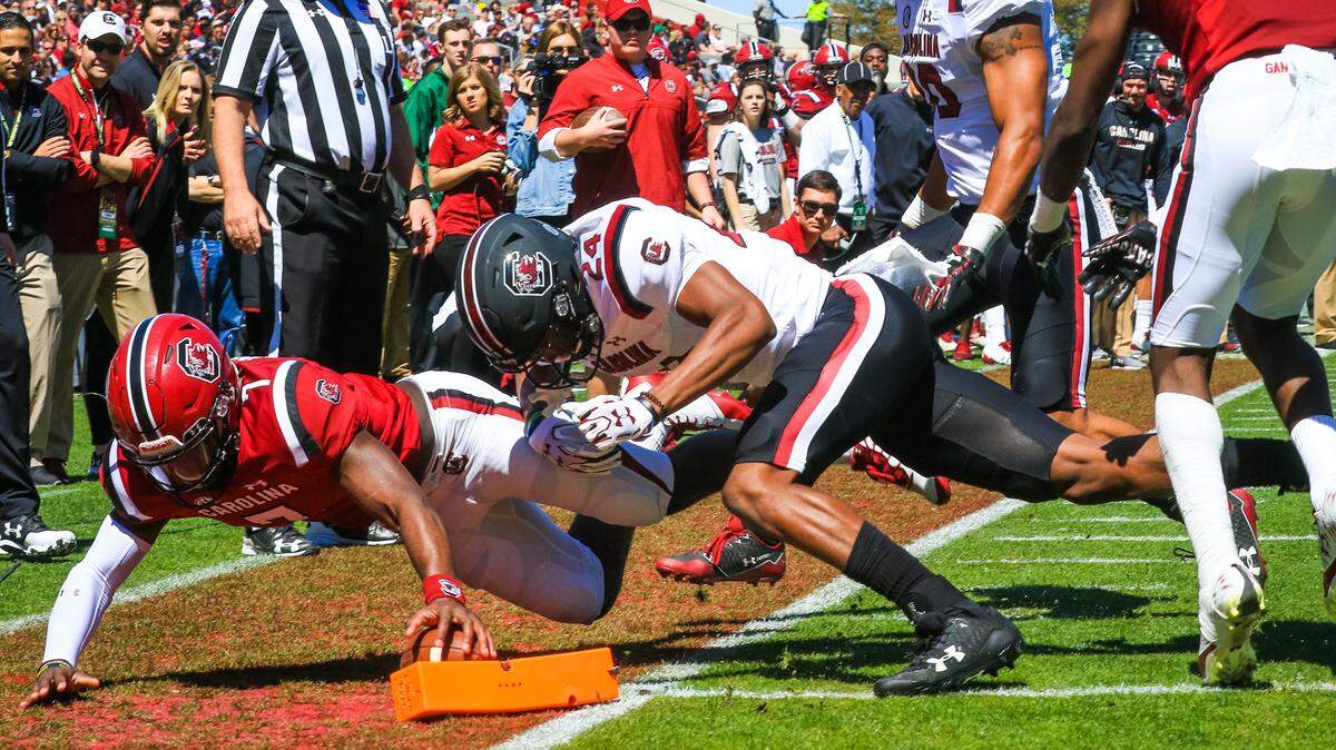 South Carolina quarterback Dakereon Joyner (7) tries to reach the ball to the pylon as defensive back Israel Mukuamu (24) pushes him out of bounds during the Garnet and Black spring game at Williams-Brice Stadium in Columbia, SC, Saturday, March 31, 2018.
