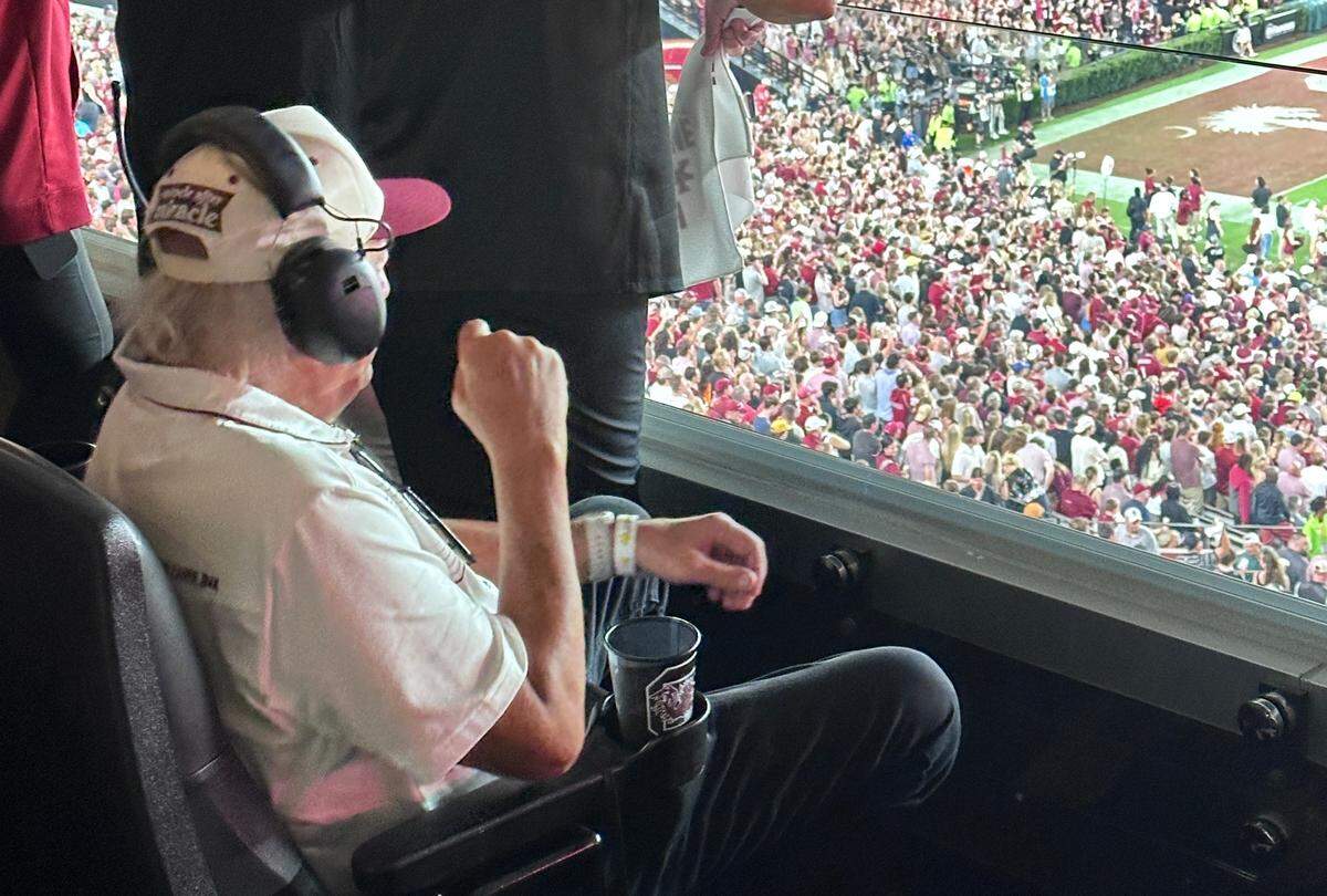 Joe Rice listens to the South Carolina radio broadcast while watching the Gamecocks live from his suite.