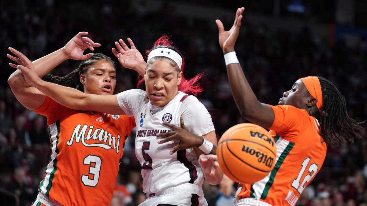 South Carolina forward Victaria Saxton (5) battles for the ball against Miami forward Destiny Harden (3) and guard Ja’Leah Williams (12) during the first half a second-round game in the NCAA college basketball tournament Sunday, March 20, 2022 in Columbia, S.C. (AP Photo/Sean Rayford)