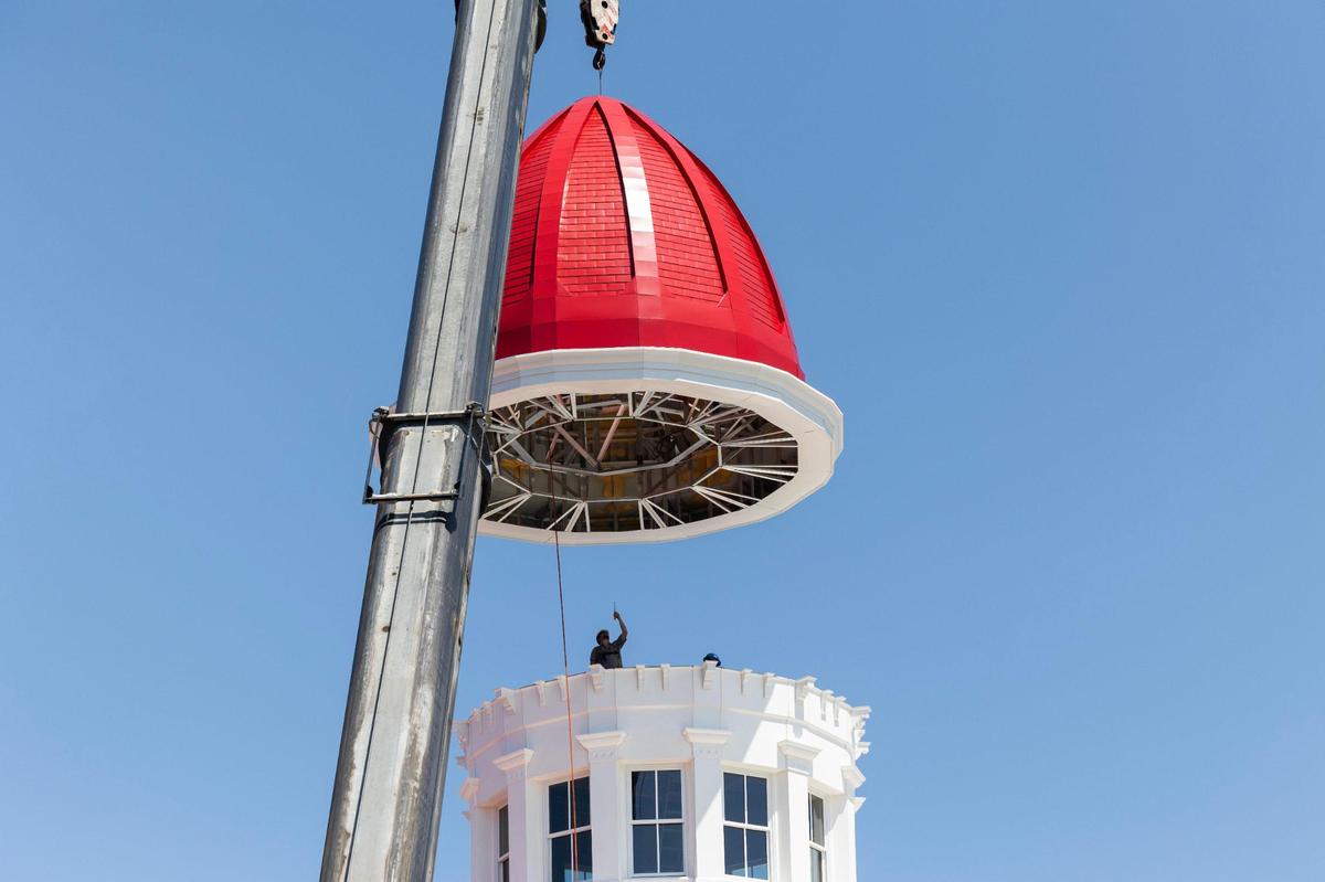 Workers install the new cupola dome at the Babcock building on Friday, August 18, 2023.
