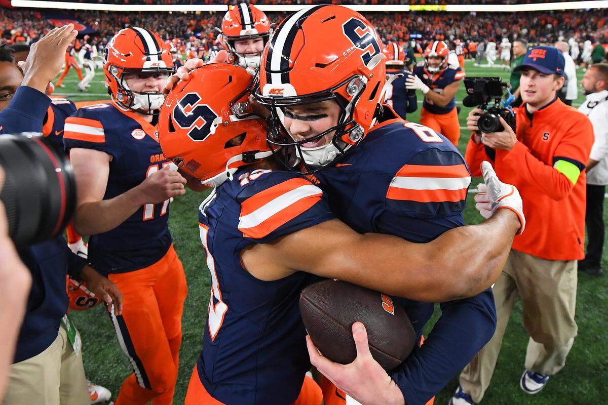 Nov 30, 2024; Syracuse, New York, USA; Syracuse Orange quarterback Kyle McCord (right) celebrates with tight end Jamie Tremble (left) following a game against the Miami Hurricanes at the JMA Wireless Dome.