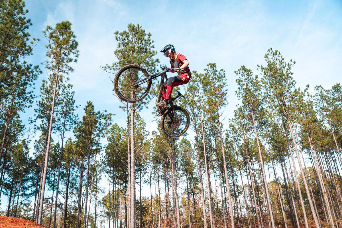 A rider jumps during opening day at Fairfield County’s Rattlesnake Bike Park.
