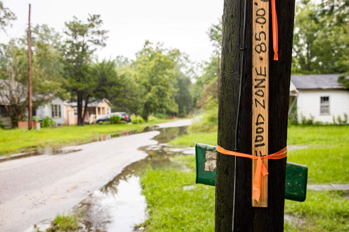 A piece of wood warns of flooding in Sellers, South Carolina on Wednesday, August 5, 2020. Some residents of the small town have had trouble getting clear title to prove they own their home, which makes it difficult to get aid after natural disasters.