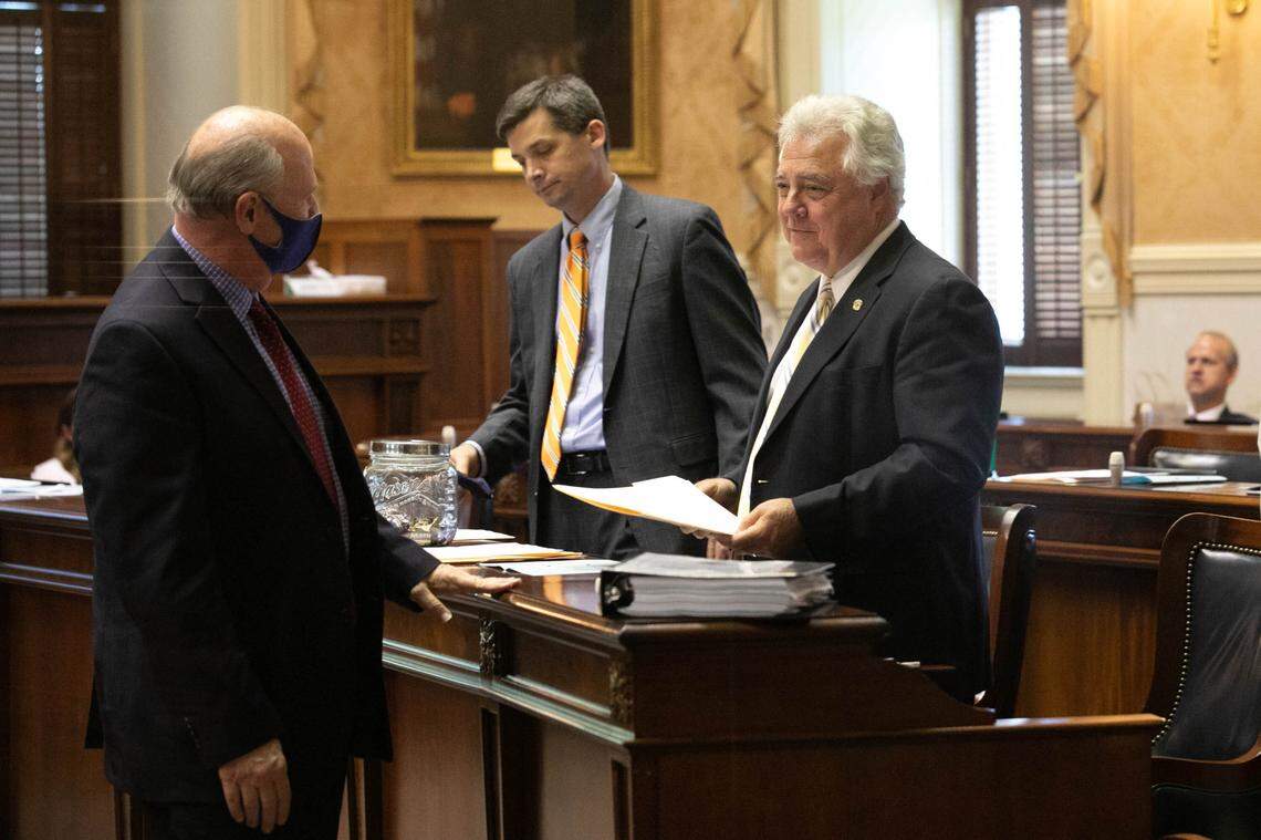 South Carolina Sen. Thomas Alexander, R-Oconee, speaks to state Sen. Larry Grooms, R-Berkeley, right, as Senate Majority Leader Shane Massey, R-Edgefield, stands at his desk in the Senate chamber on Thursday, May 13, 2021.