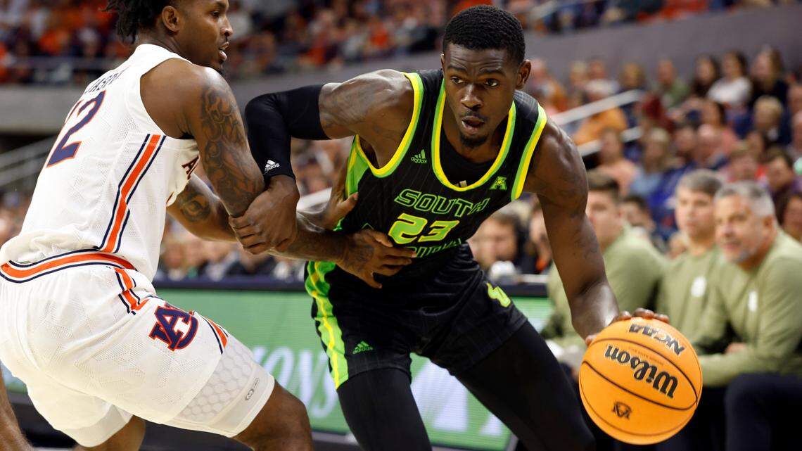 South Florida forward Keyshawn Bryant (23) drives against Auburn guard Zep Jasper (12) during the first half of an NCAA college basketball game Friday, Nov. 11, 2022, in Auburn, Ala.