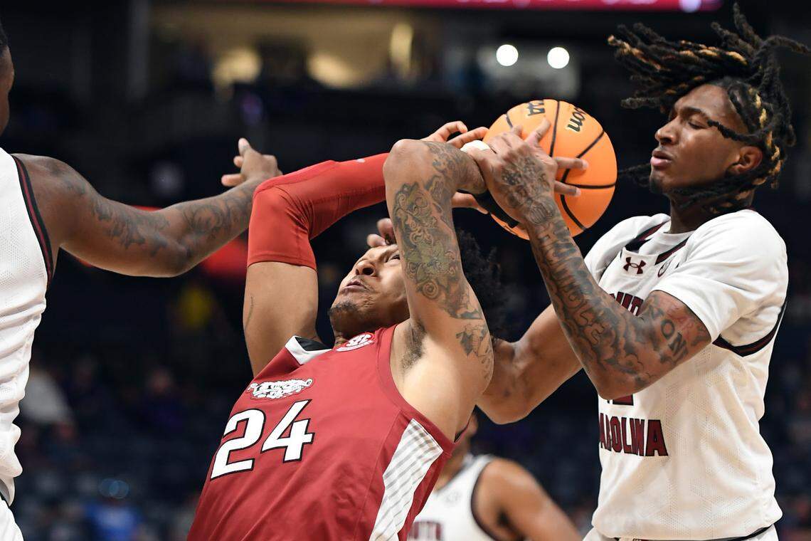 Arkansas Razorbacks guard Jeremiah Davenport (24) tries to grab a rebound against South Carolina Gamecocks guard Zachary Davis (12) during the game Thursday at Bridgestone Arena.
