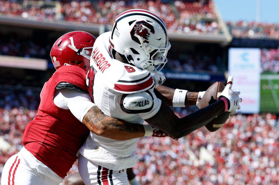 South Carolina Gamecocks wide receiver Nyck Harbor (8) catches a pass for a touchdown as Alabama Crimson Tide defensive back Domani Jackson (1) defends during the second half at Bryant-Denny Stadium.