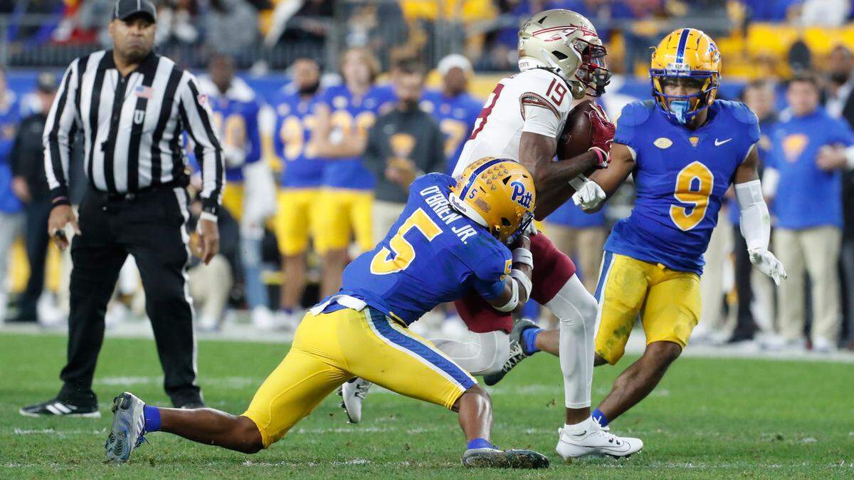 Nov 4, 2023; Pittsburgh, Pennsylvania, USA; Florida State Seminoles wide receiver Vandrevius Jacobs (19) runs after a cactch as Pittsburgh Panthers defensive back Phillip O’Brien Jr. (5) and defensive back A.J. Woods (9) defend during the third quarter at Acrisure Stadium. The Seminoles won 24-7.