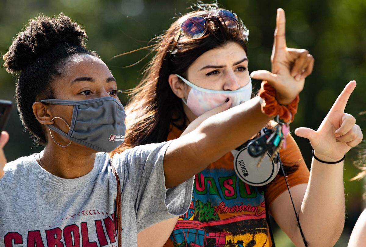 Monica Williams and Alexandra Martinez taunt supporters of President Donald Trump at the South Carolina State House in Columbia, South Carolina on Saturday, November 7, 2020. As the protestors gathered in support of the president and against conspiracy theories of rampant voter fraud, news outlets announced former Vice President Joe Biden was projected to win the election.