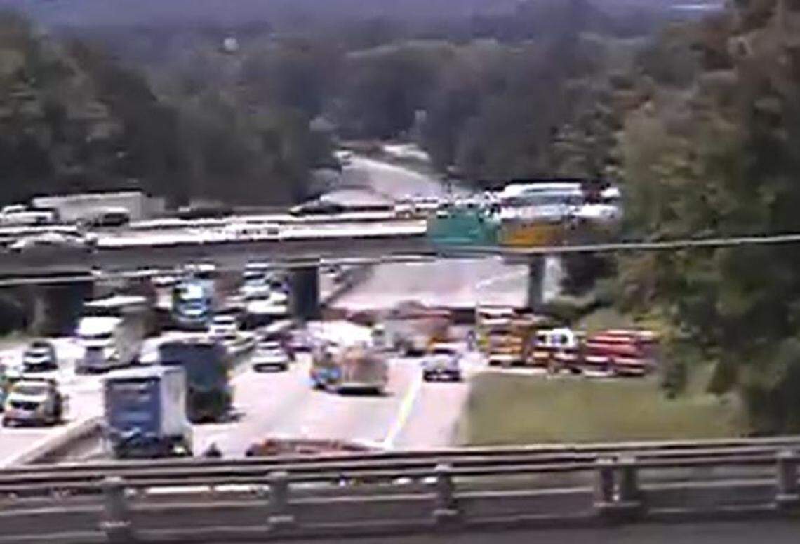 Emergency vehicles responding to a crash block multiple lanes on a highway in Columbia.