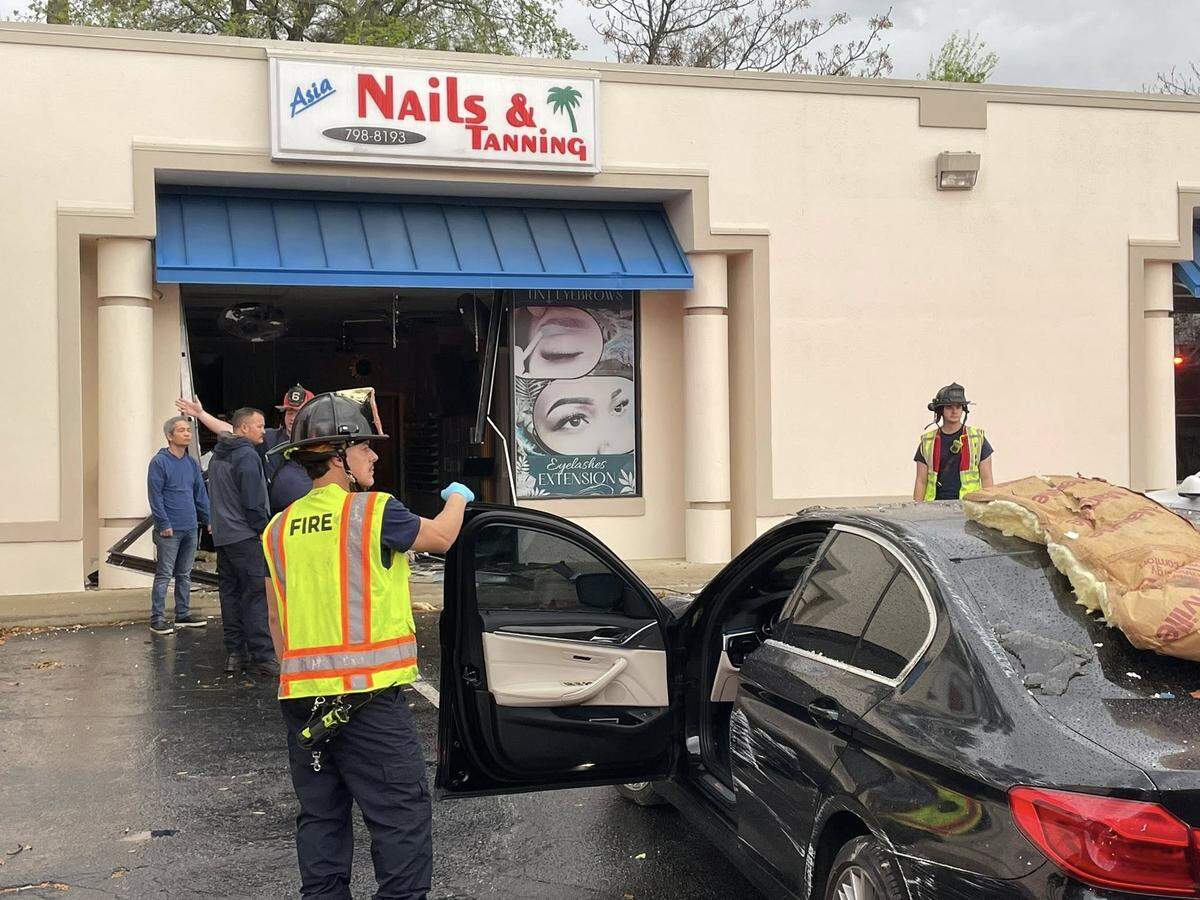 Members of the Columbia Fire Department respond to a building that was hit by a vehicle.