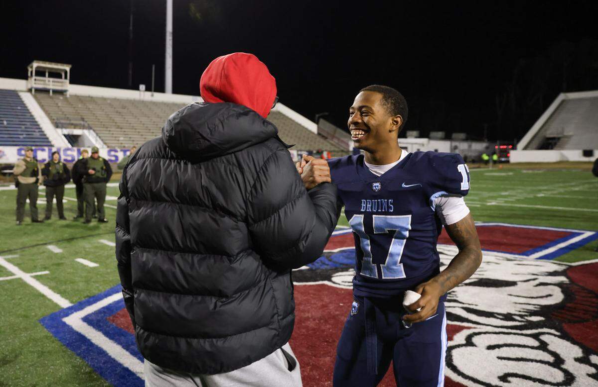 Jayden Sellers (17) of South Florence is congratulated by his brother, South Carolina quarterback LaNorris Sellers, following the Class 4A Football State Championships in Orangeburg on Friday, December 13, 2024.