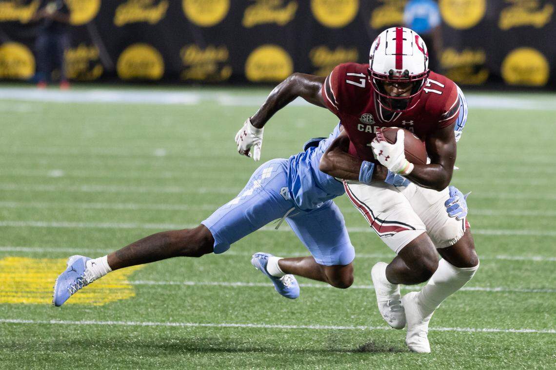 South Carolina wide receiver Xavier Legette (17) gets wrapped up by North Carolina defensive back Tayon Holloway (20) during the Gamecocks’ season opener against North Carolina at Bank of America Stadium in Charlotte on Saturday, September 2, 2023.