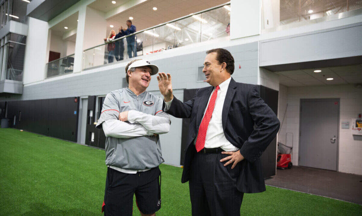 New Clemson president Ben Ayers (right) had a strong relationship with UGA football and coach Kirby Smart (left) in his previous job. He’ll look to do the same with coach Dabo Swinney and the Tigers.