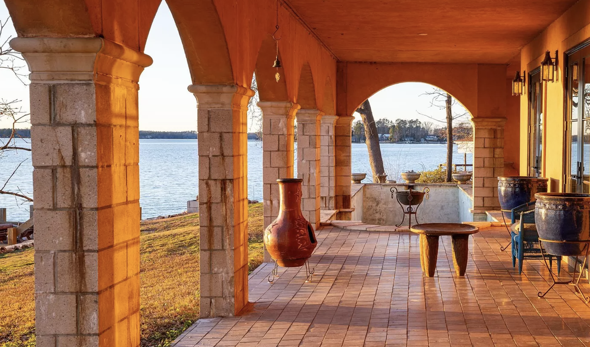 The house has a covered terrace and a patio facing Lake Murray.