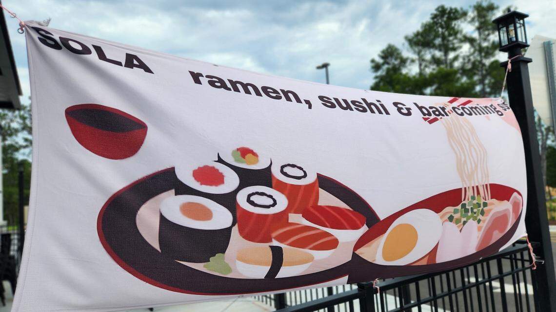 A banner announces that Sola Ramen & Sushi is coming soon at 185 Earth Road suite H in the Market at Spears Creek shopping center in Elgin near northeast Columbia.