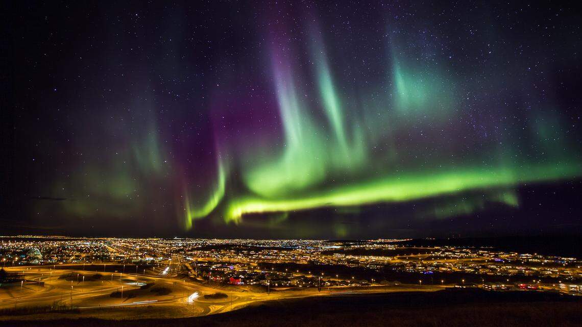The Aurora Borealis, or Northern Lights, over Reykjavik, Iceland.